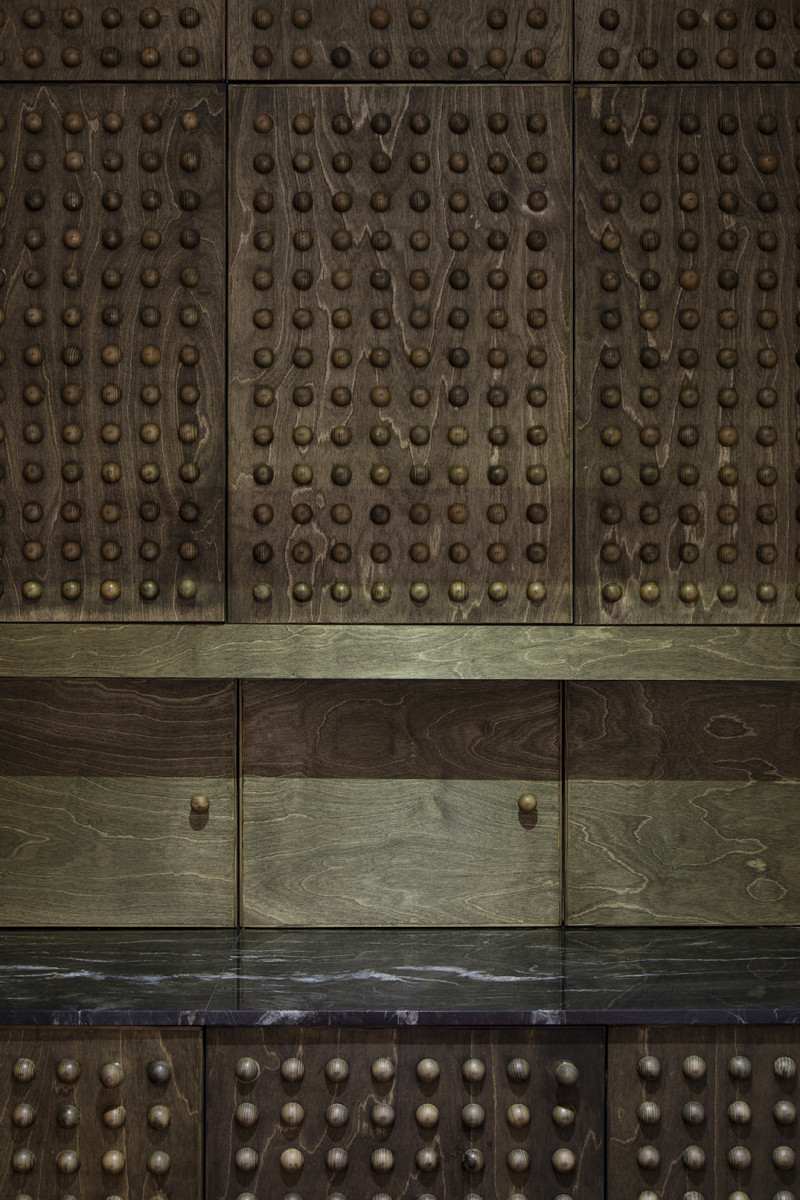 Joinery Detail showing the studs on the joinery - dark wood and granite top